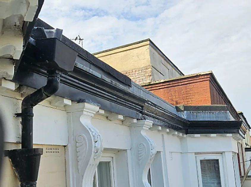 Cast iron gutter and downpipe on a period terrace in Merseyside